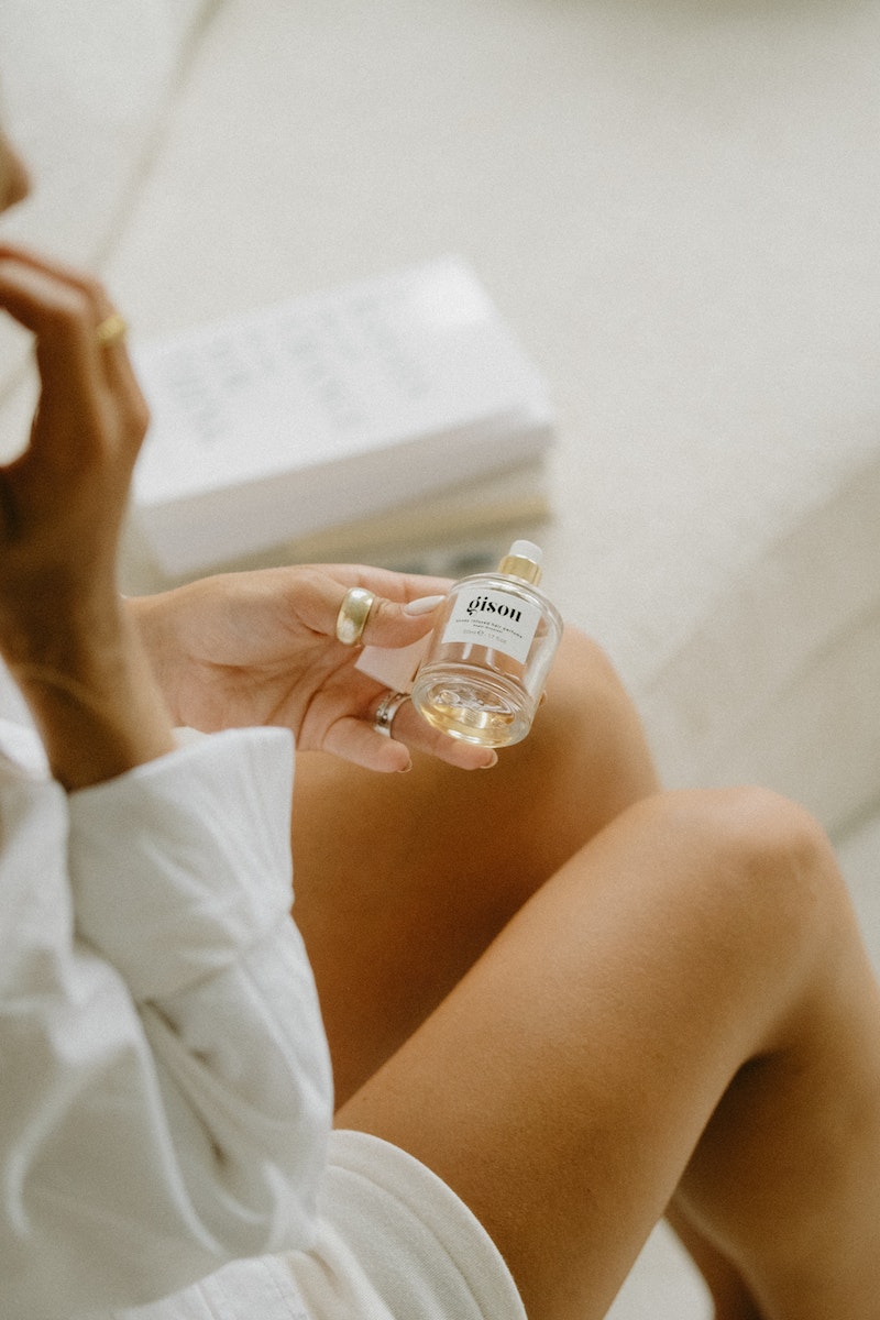 Photo par Mathilde Langevin Close-up of Woman Holding a Cosmetic Product in a Glass Container
